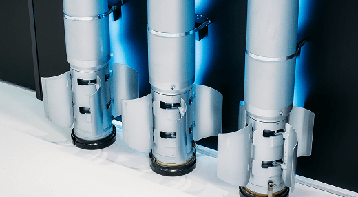 A row of four rockets stands side by side, highlighting their distinct shapes and colors in a visually striking display.